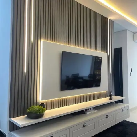 TV wall where a plain white back panel floats on a full-height beige fluted slat wall