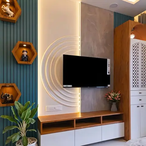 TV wall where concentric white arc mouldings with LED strips curve out from behind the screen
