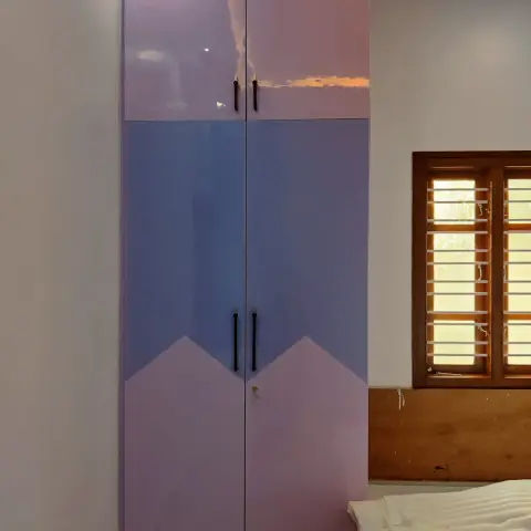 Two-door wardrobe in lilac and periwinkle high-gloss with a chevron colour-block across the shutter joint and a separate loft tier