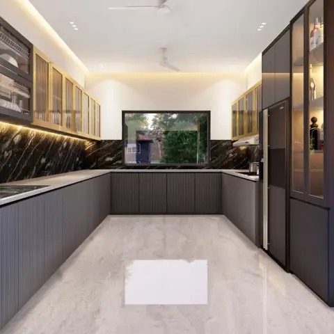 U-shaped kitchen in fluted grey shutters with brass-framed reeded-glass uppers, a black-and-gold marble backsplash band and a window centred over the far