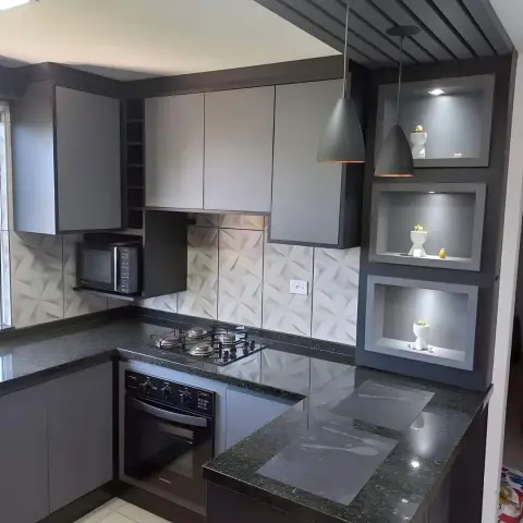 U-shaped kitchen with grey matte cabinets, a 3D textured tile backsplash, a slatted ceiling feature with cone pendant lights over the peninsula counter
