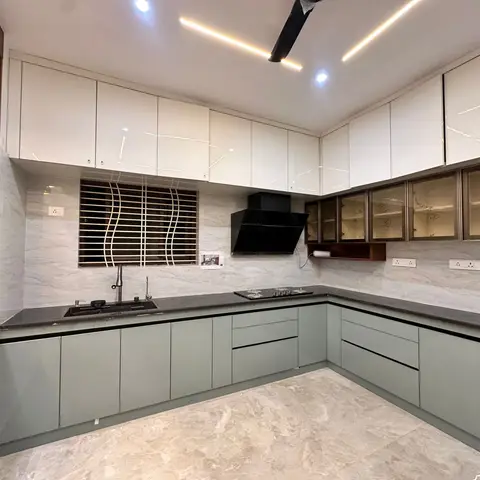 U-shaped kitchen with sage-grey base cabinets, glossy white uppers and glass-front display cabinets, black granite counter and marble backsplash