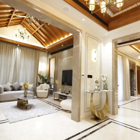 Villa living room under an exposed timber rafter roof with cove light along the ridge and a brass candelabra chandelier
