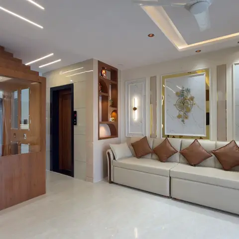 Villa living room with a taupe leather sofa facing a wall of framed marble-look art panels lit by brass wall sconces