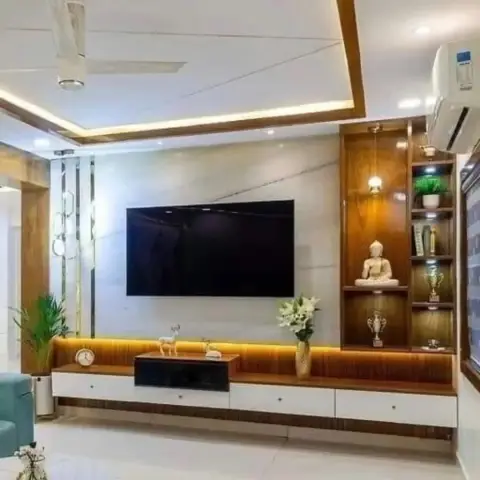 Wall-hung teak-veneer TV console with white drawer fronts and a warm LED strip washing its fluted back panel