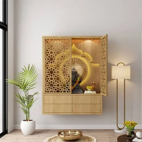 Wall-mounted pooja unit with jaali-pattern doors open to reveal a backlit arch niche housing the Ganesh idol.