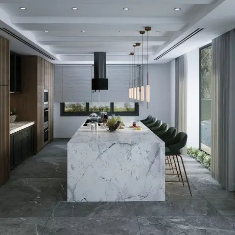 Waterfall-edge marble kitchen island with green velvet bar stools and a cluster of brass pendant lights, walnut tall units behind
