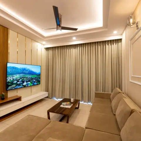 Watermarked render of a narrow living room where a teak fluted panel and a cream fluted panel with brass reveals carry the TV above a white floating console