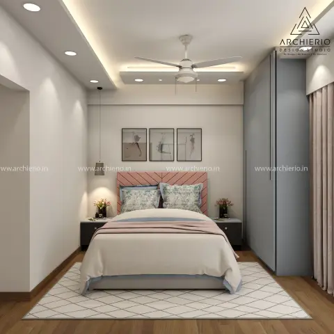 Watermarked render of a small bedroom with a blush chevron-tufted headboard between black-topped nightstands, three abstract prints