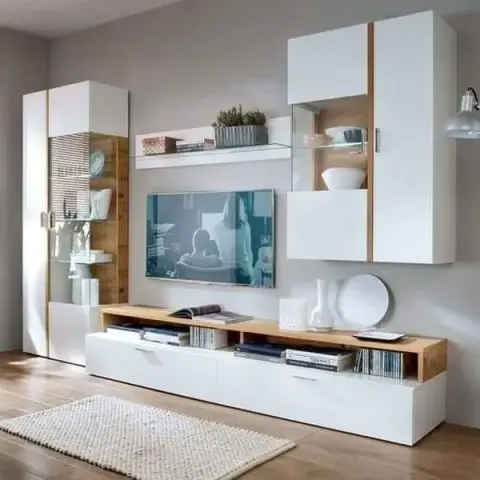 White-and-oak modular media wall with two lit glass display towers flanking a wall-hung TV