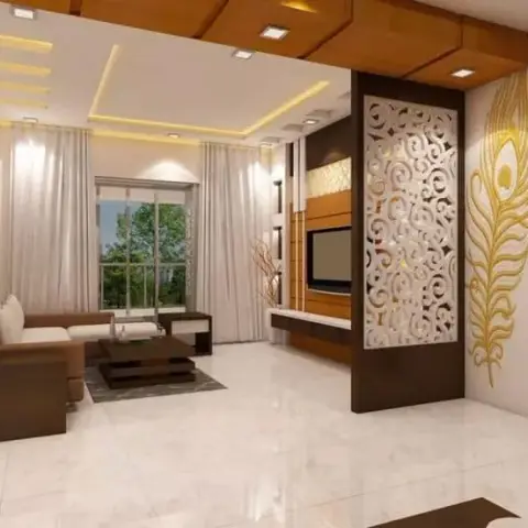White CNC swirl-jaali partition splits the sofa area from a gold peacock-feather mural on the wall beside a slatted wood accent wall.
