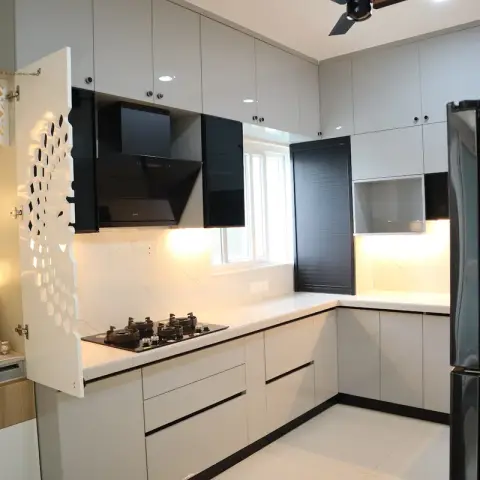 White gloss L-shaped kitchen with black glass accent units and black skirting, an angled chimney over the hob