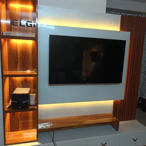 White gloss TV feature wall with warm LED backlighting, a solid-wood floating console shelf and a fluted wood side panel