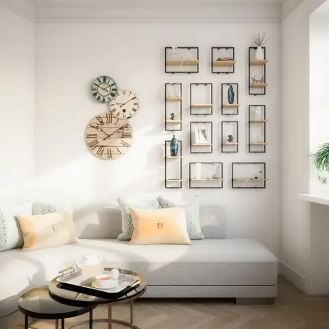White living corner with a grid of black wire-frame box shelves holding small ceramics, three overlapping vintage-face clocks alongside