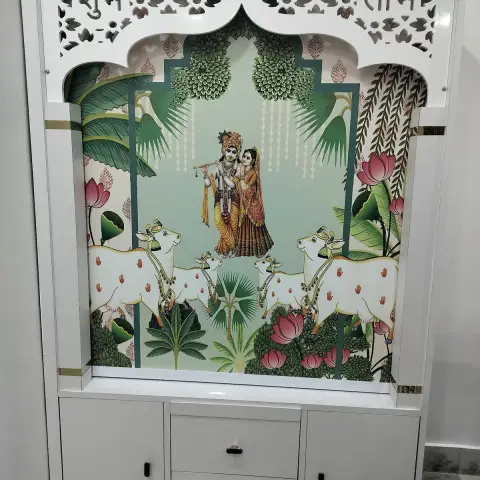 White pooja unit with a CNC-cut jaali pelmet spelling Shubh Labh over a cusped arch