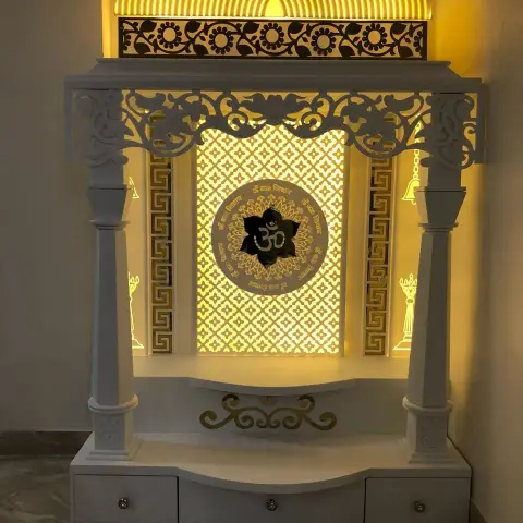 White temple unit built into a corner, with turned pillars, a carved lotus valance