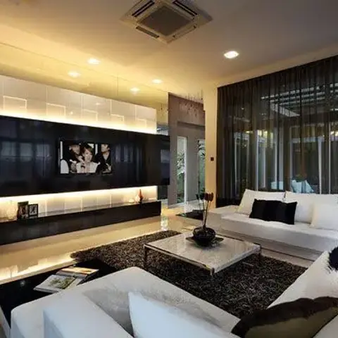 Wide living room where a glossy black feature panel holding the TV is set into a grid of white square wall tiles lit from behind
