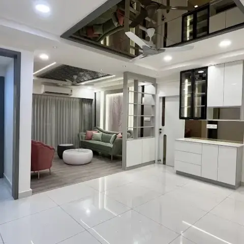 Wide open hall in high-gloss white tile with a bronze-mirror-lined ceiling recess over the fan, a white crockery unit with black-framed glass display cabinets
