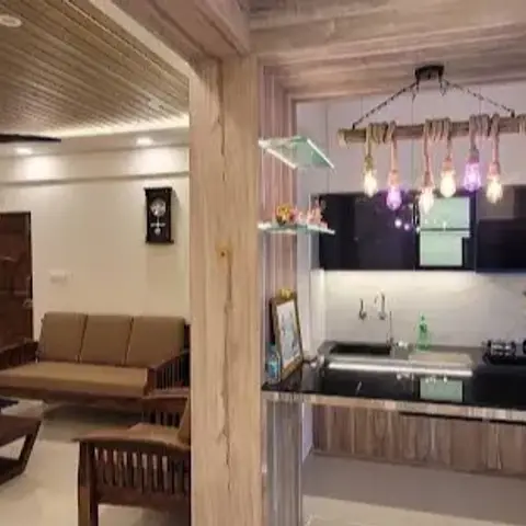 Wide open-plan frame from a wood-clad archway: a brown fabric sofa and low teak coffee table under a slatted wood ceiling on the left