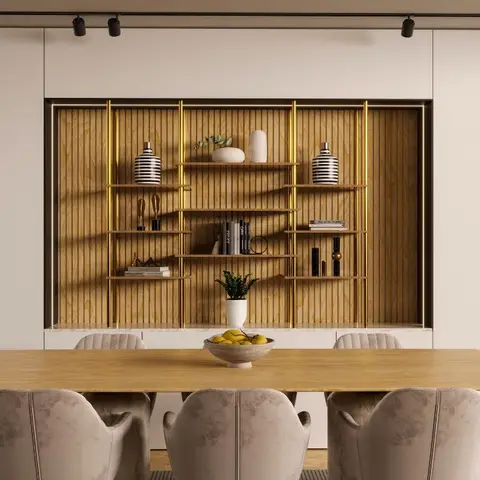 Wood dining table with scalloped taupe velvet chairs facing a built-in fluted-wood display shelving unit with brass trim and styled objects.