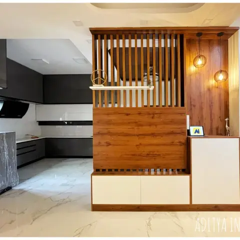 Wood-slatted foyer partition and console unit with rattan pendant lights dividing the entrance from an open dark modular kitchen.