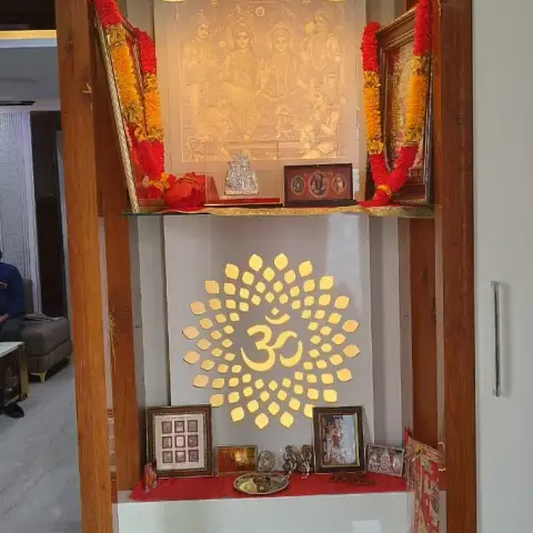 Wooden pooja unit with twin gold pendant lights, a backlit Ram Darbar panel, a golden Om medallion, and a white marble step-up base.